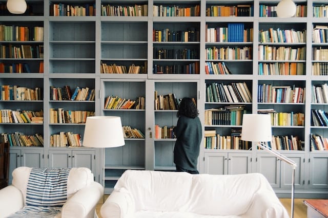 self storage -women student looking at her home library.