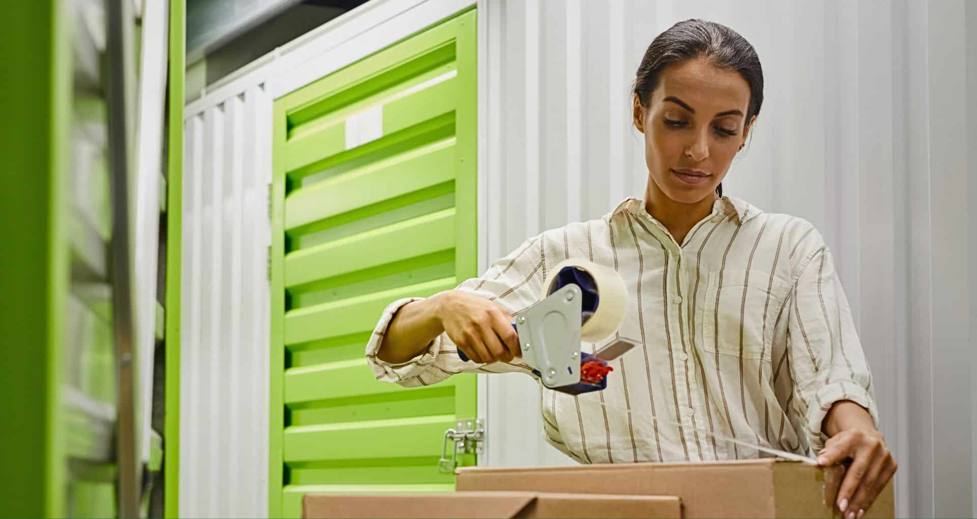 self storage women taping up a carboard box